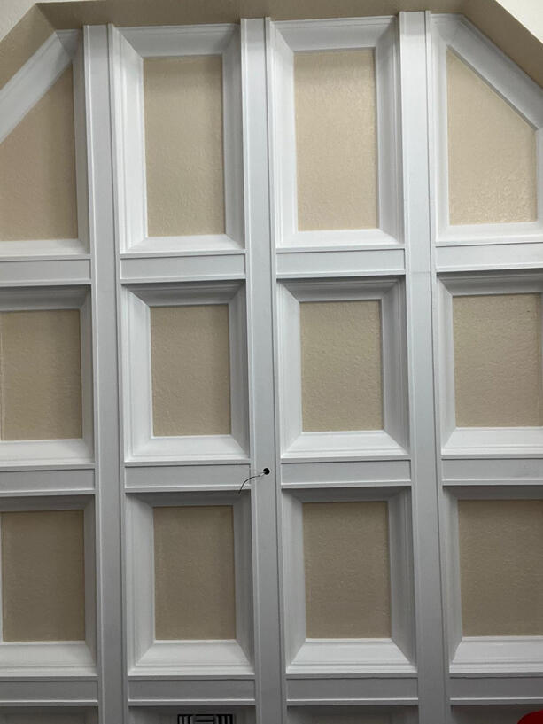 Custom Wall Paneling – Classic Meets Contemporary This expertly crafted wall showcases our commitment to detail and design. Featuring symmetrical panel molding with clean white framing against a neutral backdrop, it blends timeless craftsmanship with a mod